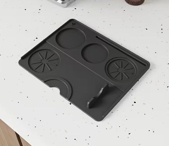 black tamp mat on white bench top 