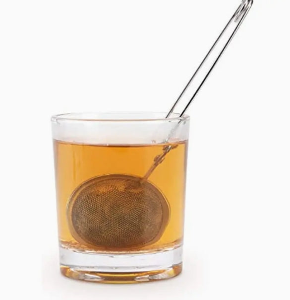 Tea ball in a glass of tea on a white background